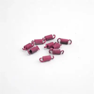 Nine Pink Draggin Skin Clutch Springs Laying in a Pile Next to Each Other.