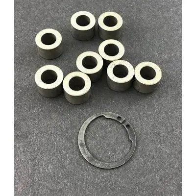 A 10-Piece, 10 Gram Draggin Skin Clutch Weight Kit with 9 Cylindrical Weights Standing Upright Next to a Snap Ring.