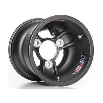 A Black, Douglas Metric 5" x 130 LV Magnesium Kart Racing Wheel Laying on It's Side.