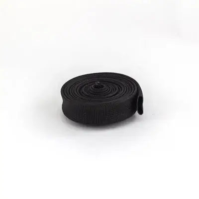 A Black, Ten Foot Coiled Up Roll of 7/8" Braided Exhaust Header Sleeve Wrap for a Spec RLV 5507 Exhaust Pipe.